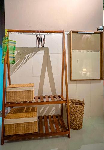a room with a shelf with baskets and a mirror at Chang's Hideaway homestay ConDao in Con Dao