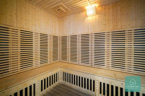 a wooden room with wooden shutters on the wall at JOMSTAY Sunway Onsen Suites Ipoh - Lost World of Tambun Ipoh Waterpark in Tambun