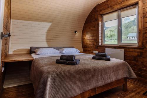a bedroom with two beds in a room with a window at Рибничанка in Skhidnitsa