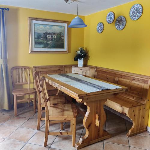 a dining room with a wooden table and chairs at Al Dos in Livigno