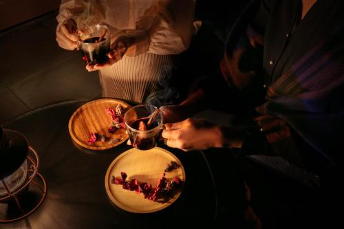 a person drinking from a vase on a table at AWA Nishi-Izu in Numazu