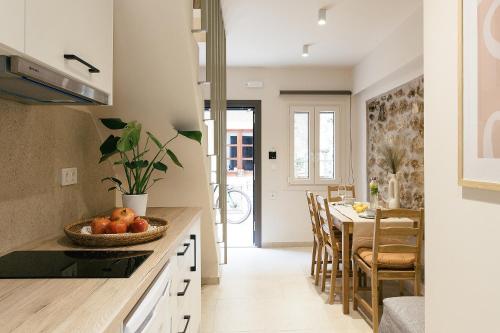a kitchen and dining room with a table and chairs at Limeria studios & maisonettes in Parga
