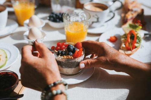 a person eating a bowl of food on a table at Ferienhaus Knor in Umhausen