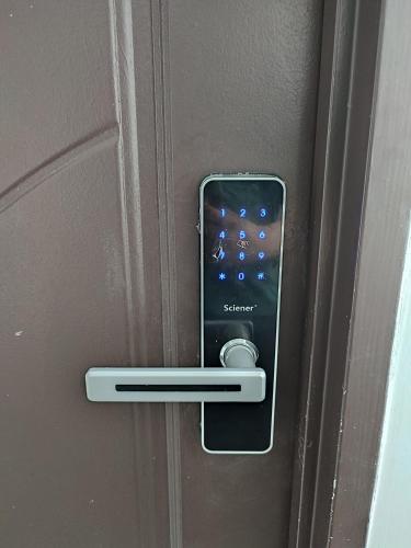 an iphone in a lock on a door at Cozy Condo at Melaka Top Hill, 7-9pax in Ayer Keroh