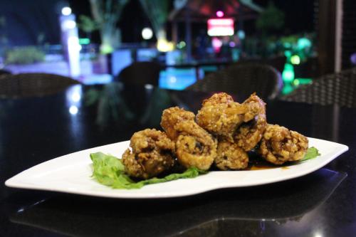 a plate of food with shrimp on a table at Prime Asia Hotel in Angeles