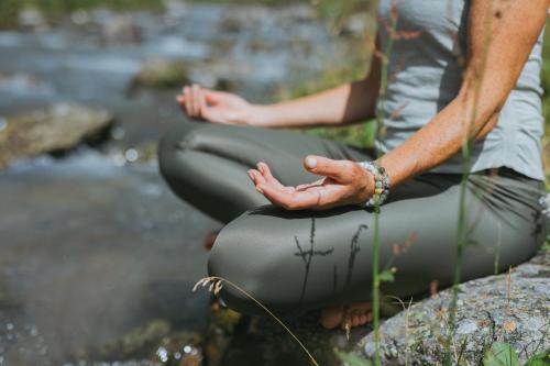 two people sitting on a rock with their hands on their legs at Ferienhaus Knor in Umhausen