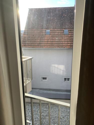 a balcony with a view of a white building at Apartment Metzingen Outlet City Business Zentral Modern in Metzingen