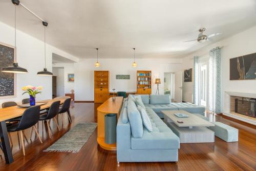 a living room with a blue couch and a table at Big Blue in Piso Livadi