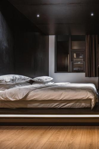 a bedroom with a large bed with a black headboard at Xi'an Desti Youth Park Hostel Bell & Drum Tower in Xi'an