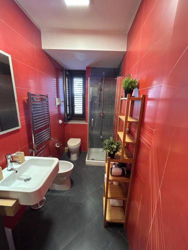 a bathroom with a sink and a toilet and a shower at Vicolo Appalto Apartment in Palermo