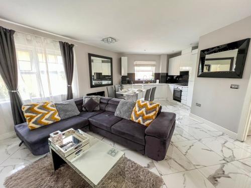 a living room with a couch and a table at 2 Double Bedroom Apartment in Edgware, London in Edgware