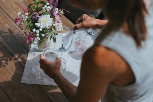 a woman sitting at a table with wine glasses at Ferienhaus Knor in Umhausen