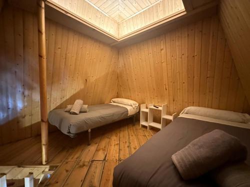 a room with two beds and a skylight at SIERRA NEVADA LOS ALAYOS ESTACION DE ESQUI in Sierra Nevada