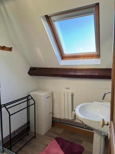 a bathroom with a sink and a window at LAETITIA ET CLAUDE in Lille