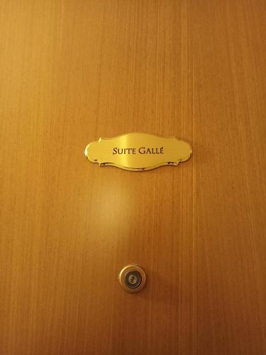 a sign on a door that says suite gate at Aparthotel Dei Mercanti in Milan