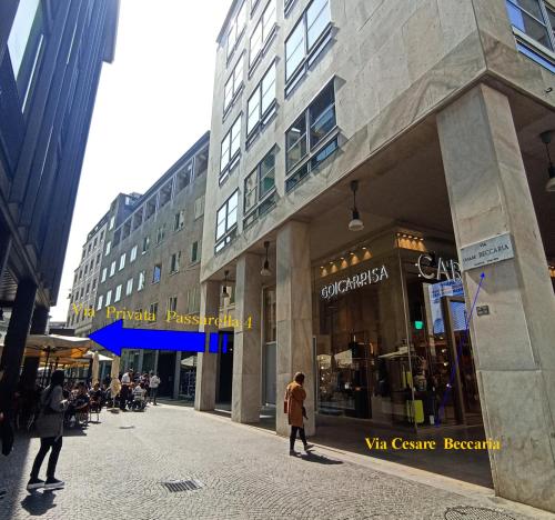 a building on a street with people walking in front of it at Aparthotel Dei Mercanti in Milan