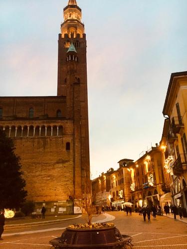 a clock tower in the middle of a city at Casa di Zelda in Cremona