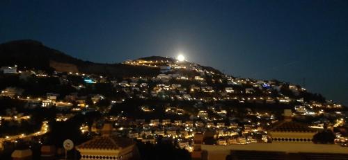 a city lit up at night with a mountain at Villa de Standing Vue Mer in Altea