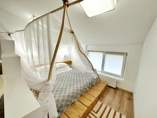 Higina Spa Hotel في تريسكوفيتس: غرفة نوم بسرير مع مظلة