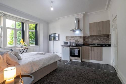 a bedroom with a large bed and a kitchen at City Studio: Studio Suite 2 in Parkside