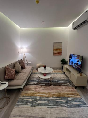 a living room with a couch and a tv at Your home 2 in Jeddah
