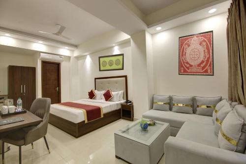 a hotel room with a bed and a couch at Hotel La Mirage in Noida