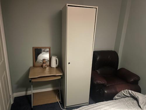 a bedroom with a mirror and a chair and a bed at 1 bedroom in 3bed house in Bristol