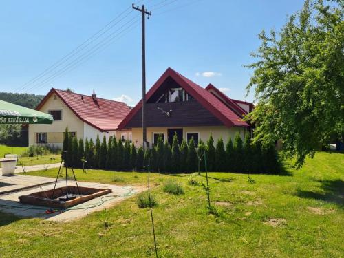a house with a bunch of trees in the yard at Apartments Beskydy in Prostřední Bečva
