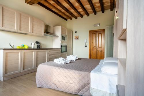 a bedroom with a bed with towels on it at Castello di Marano sul Panaro - Room & Breakfast in Marano sul Panaro