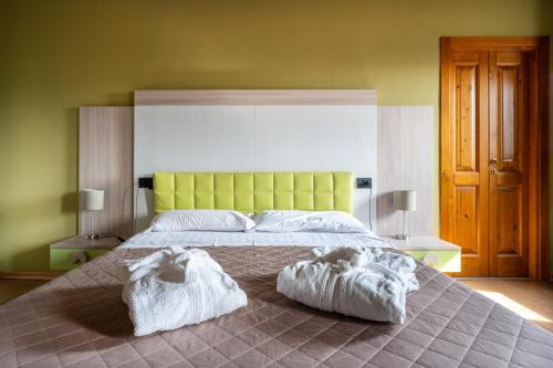 a bedroom with a large bed with two towels on it at Castello di Marano sul Panaro - Room & Breakfast in Marano sul Panaro