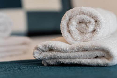 a white towel sitting on top of a table at The Willows Penthouses with Jacuzzi in Għajn il-Kbira