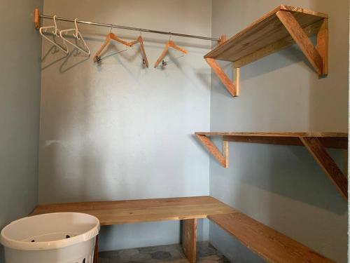 een badkamer met een toilet en houten hangers bij Story Villa 1 Bedroom with Ocean & Mountain View in Canaries