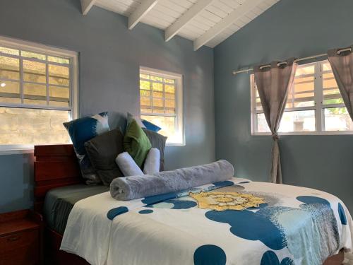 a bedroom with a bed with blue walls and windows at Story Villa 1 Bedroom with Ocean & Mountain View in Canaries