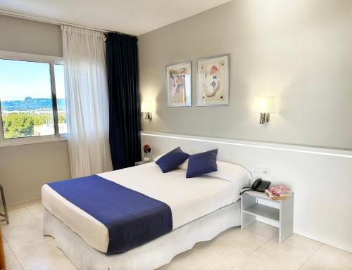 Postel nebo postele na pokoji v ubytování Aparthotel SunClub Salou