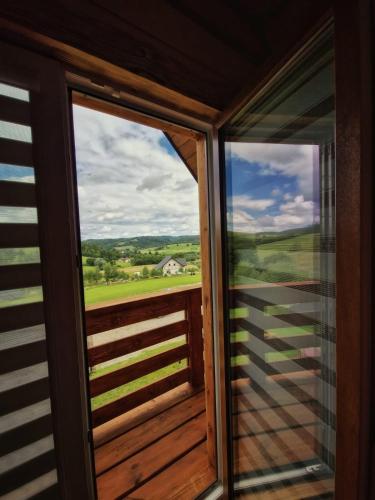 a view from the window of a house with a view at Kryjówka Yetiego Domek w zaciszu Bieszczad z jacuzzi in Hoczew