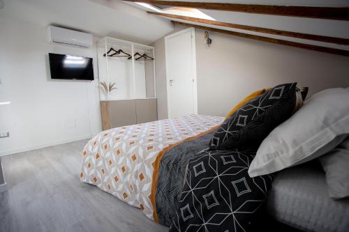 a bedroom with a bed and a television in it at Domus 25 in Catania