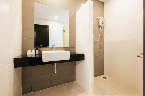 a bathroom with a sink and a shower at Vivace Hotel in Kamala Beach