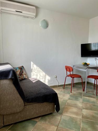 a living room with a couch and a table at Garden Apartment in Selca