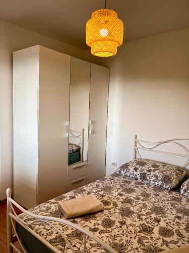 a bedroom with a bed and a white cabinet at Garden Apartment in Selca