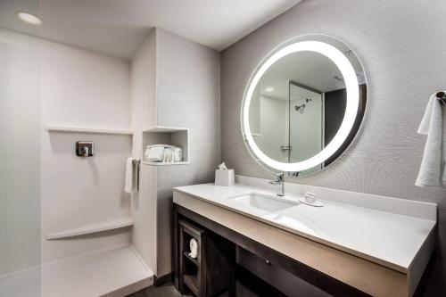 a bathroom with a sink and a mirror at Courtyard by Marriott Pensacola I-10 West in Pensacola