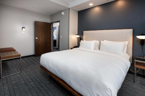 a large white bed in a hotel room at Courtyard by Marriott Pensacola I-10 West in Pensacola