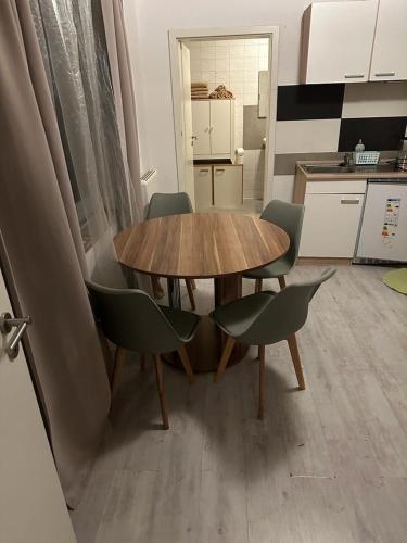 a wooden table and chairs in a kitchen at Wohnung in Sankt Englmar Nr 415 in Sankt Englmar
