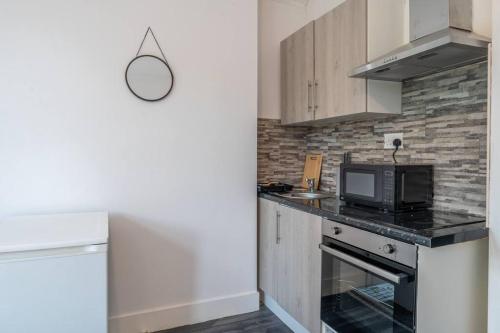 a kitchen with a counter top with a microwave at Parkview Studio: Studio Suite 9 in Parkside