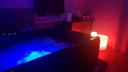 a room with a tub with a lit candle at Une Parenthese in Floirac