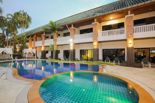 a swimming pool in front of a hotel at ETK Patong Resort in Patong Beach
