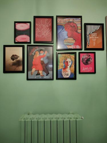 a group of pictures hanging on a wall at Il Vicoletto Holiday Rooms in Spoleto