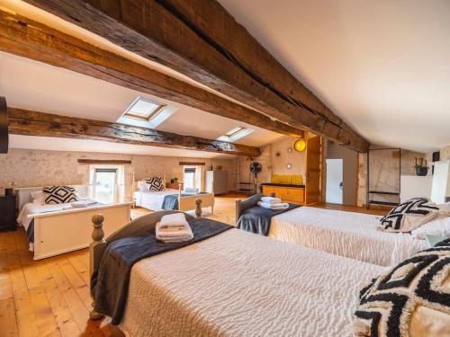 a bedroom with three beds in a room at LE GRAND FRANC gite cosy proche tous commerces in Tonnay-Charente