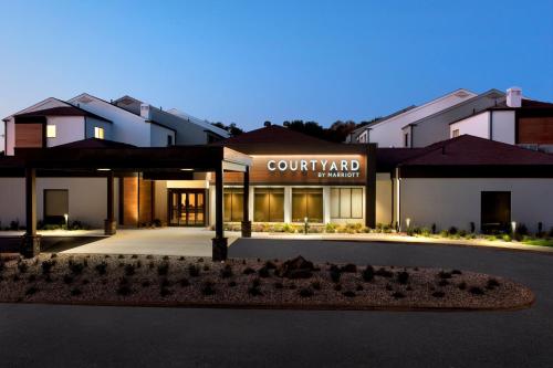 a view of a building with a court yard sign at Courtyard by Marriott New Haven Wallingford in Wallingford