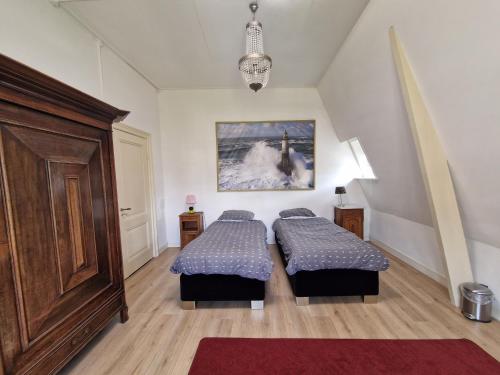 a bedroom with two beds and a large door at J&J in Nijmegen