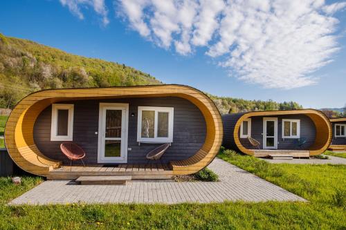 a modular home with two chairs in front of it at Рибничанка in Skhidnitsa